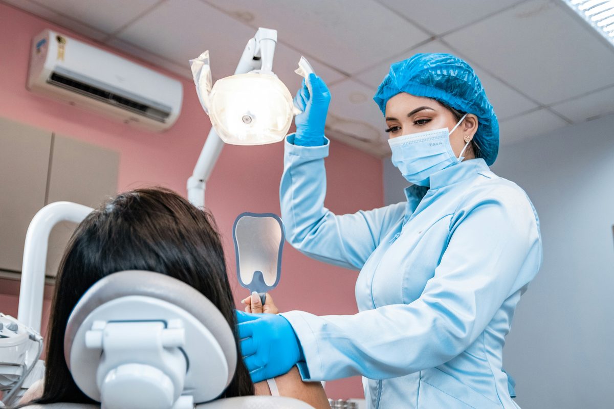 Dentist carrying out a dental check-up on a patient at Queens Dental Practice